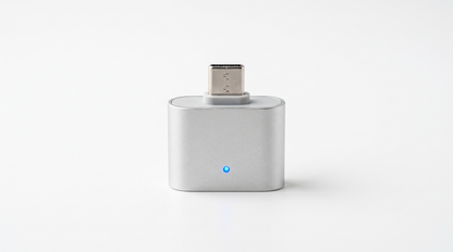 Auto-Disconnect Overcharge Protector — matte silver USB-C adapter with a blue charging status LED, studio shot