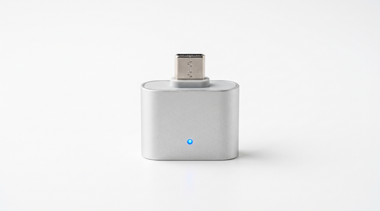 Auto-Disconnect Overcharge Protector — matte silver USB-C adapter with a blue charging status LED, studio shot